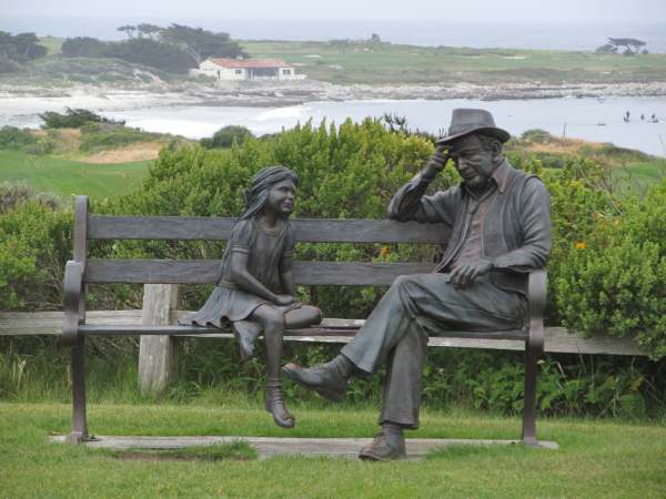 Park bench with statues along the 17-Mile-Drive from Carmel to Pacific Grove