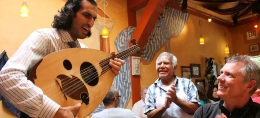 Musician playing for customers at the Dametra Cafe in Monterey, California