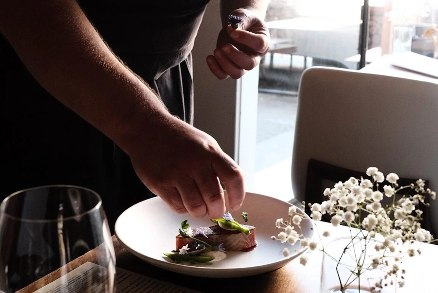 Preparing a Dish at the Eden Hill Restaurant in Seattle