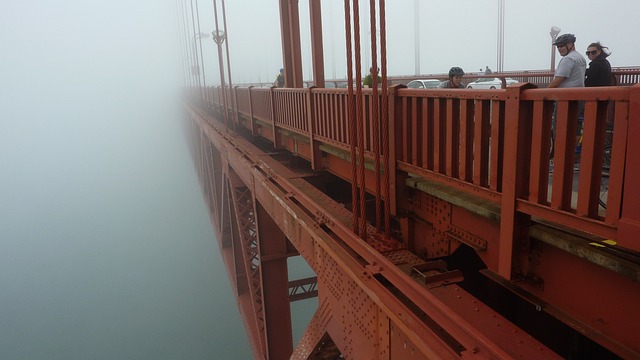 People walking along the walkways at the side of the Golden Gate Bridge in San Francisco on a misty day
