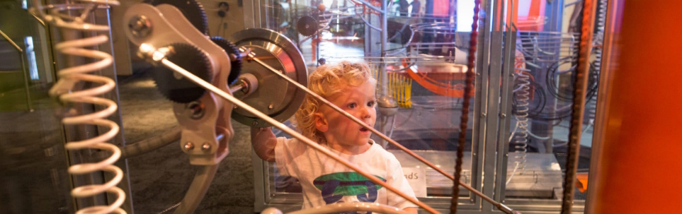 A child inside the giant guitar exhibit at the MOXI museum in San Francisco