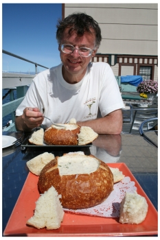 Mike of Pacific Coast Highway Travel tucks into clam chowder on Fisherman's Wharf in Monterey