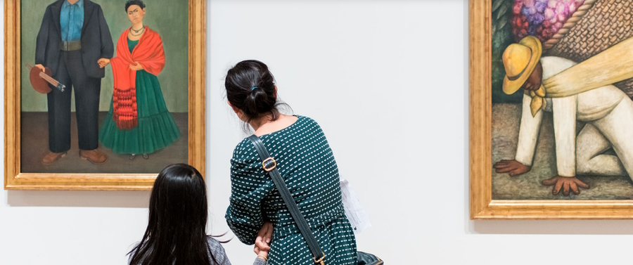 Mother and daughter looking at paintings in the San Francisco Museum of Modern Art