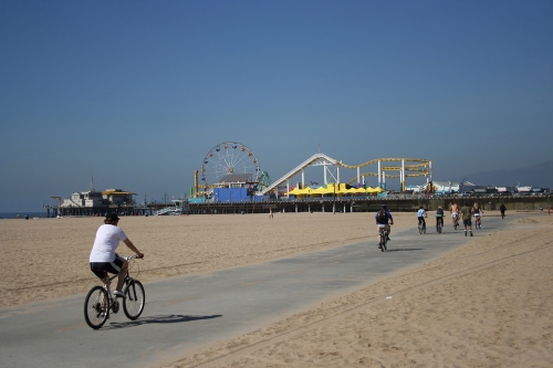 Cyclists by the beach and near Santa Monica Pier in California, from https://www.pacific-coast-highway-travel.com/Santa-Monica-California.html