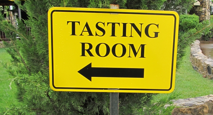 Photograph of a sign for a winery tasting room on the Pacific Coast Highway in California